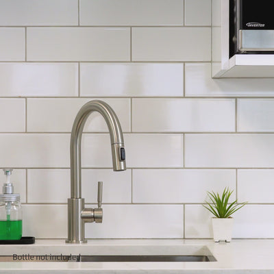 A woman is filling up a water bottle with the Santevia Water Bottle Filter that filters chlorine, then adds healthy minerals to create great tasting water